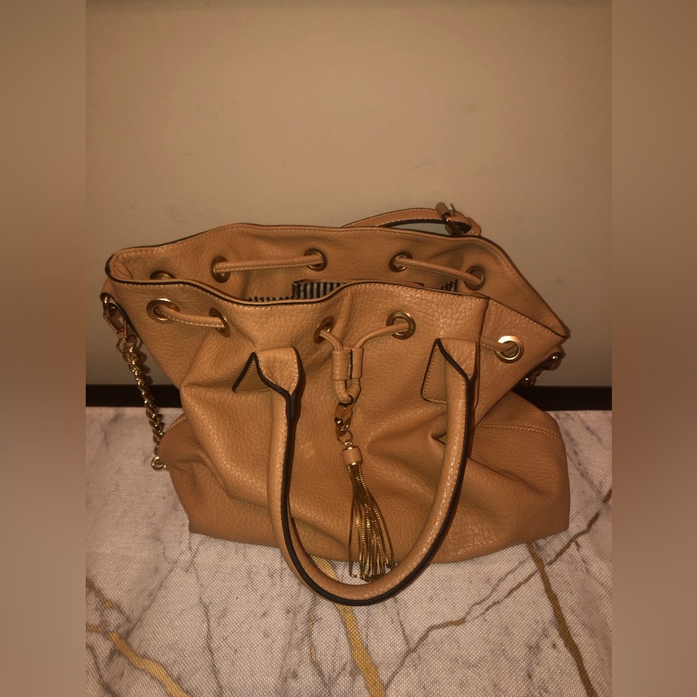 Handbag with black and white stripes inside; classy bag can dress up or down